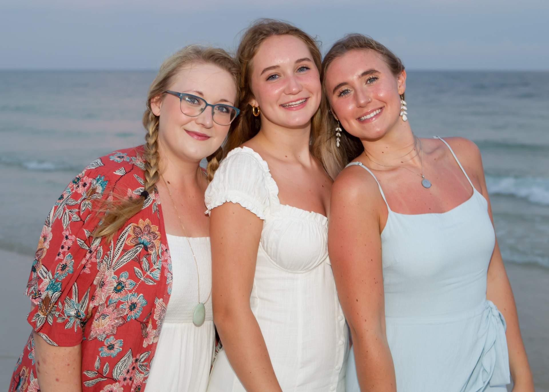Katie and her two sisters together at the beach