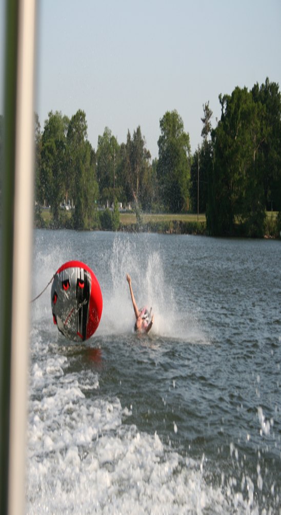 A family tubing adventure, with the tube and rider splashing across the lake